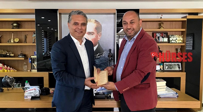Eşinin şiir kitabını  imzalayıp hediye etti