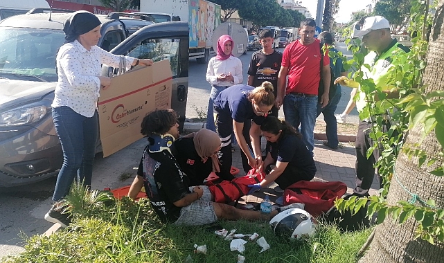 Yerde acı içerisindeki yaralıyı yakıcı güneşten kartonla korudular