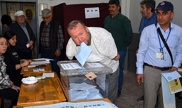Kolları olmayan seçmen, oyunu kullanıp zarfı ağzıyla sandığa attı