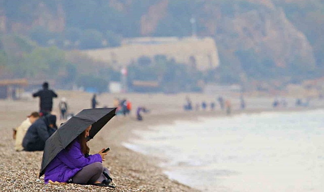 Antalya'da yağmura rağmen şemsiye altında deniz keyfi
