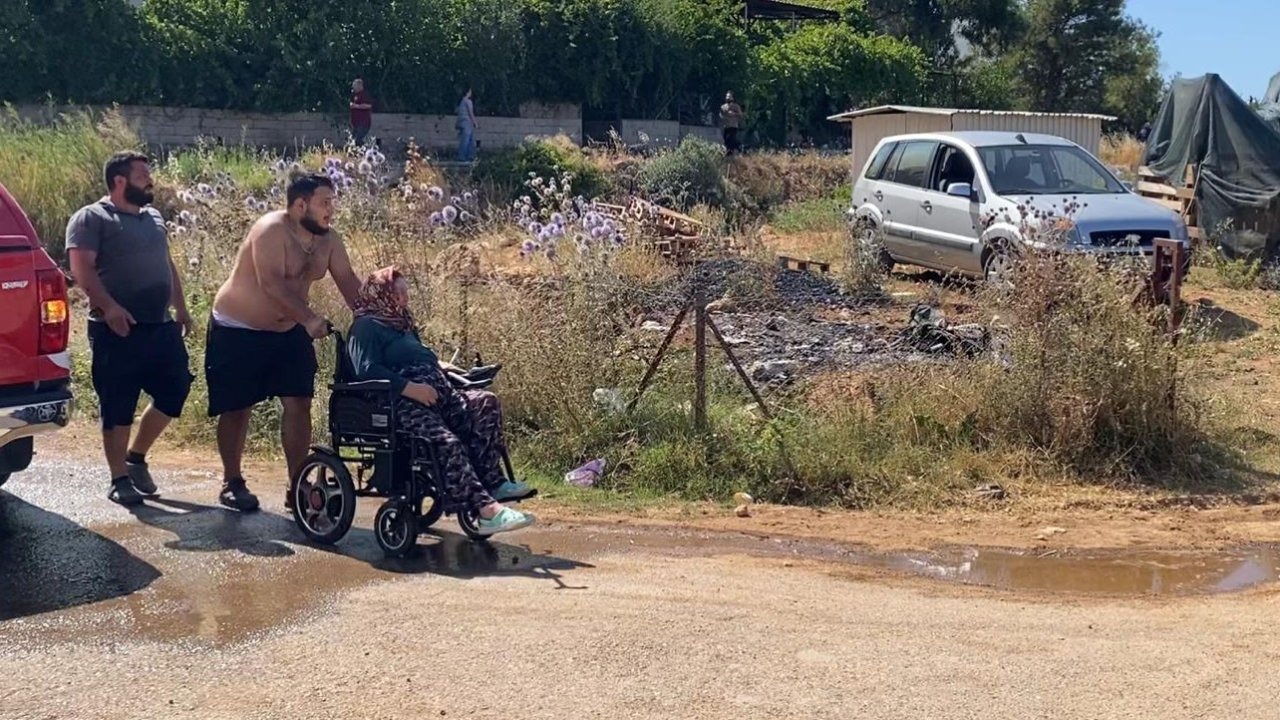 Evine yaklaşan alevlerden kurtarılan kadın tekerlekli sandalyeyle bölgeden uzaklaştırıldı